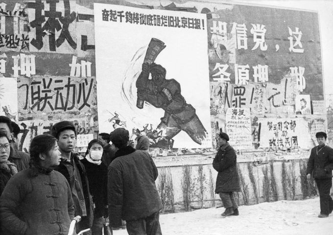 BEIJING, CHINA - JANUARY21: A small group of Chinese youths walk past several dazibaos, the revolutionary placards, in February 1967 in downtown Beijing, during the "Great Proletarian Cultural Revolution". Since the the cultural revolution was launched in May 1966 at Beijing University, Mao's aim was to recapture power after the failer of the "Great Leap Forward". (Photo credit should read JEAN VINCENT/AFP/Getty Images)