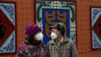 Китайская пара в защитных масках во время празднования китайского Нового года, Пекин, Китай, 26 января 2020 года. Kevin Frayer/Getty Images