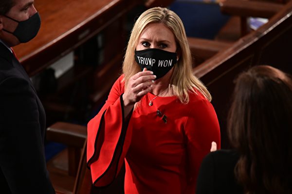Член Конгресса США Марджори Тейлор Грин с маской «Трамп победил» появилась в зале Палаты представителей, чтобы принести присягу в качестве недавно избранного члена 117-й Палаты представителей в Вашингтоне, округ Колумбия, 3 января 2021 года. ERIN SCOTT/POOL/AFP via Getty Images