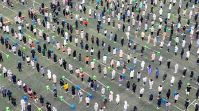 Вид с воздуха на людей, стоящих в очереди на тестирование нуклеиновой кислоты COVID-19 в Тяньцзине, Китай, 20 января 2022 года. (VCG/VCG via Getty Images)